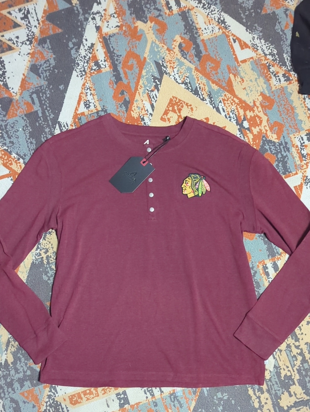 Chicago Blackhawks Henley shirt with a button placket and a team logo embroidery